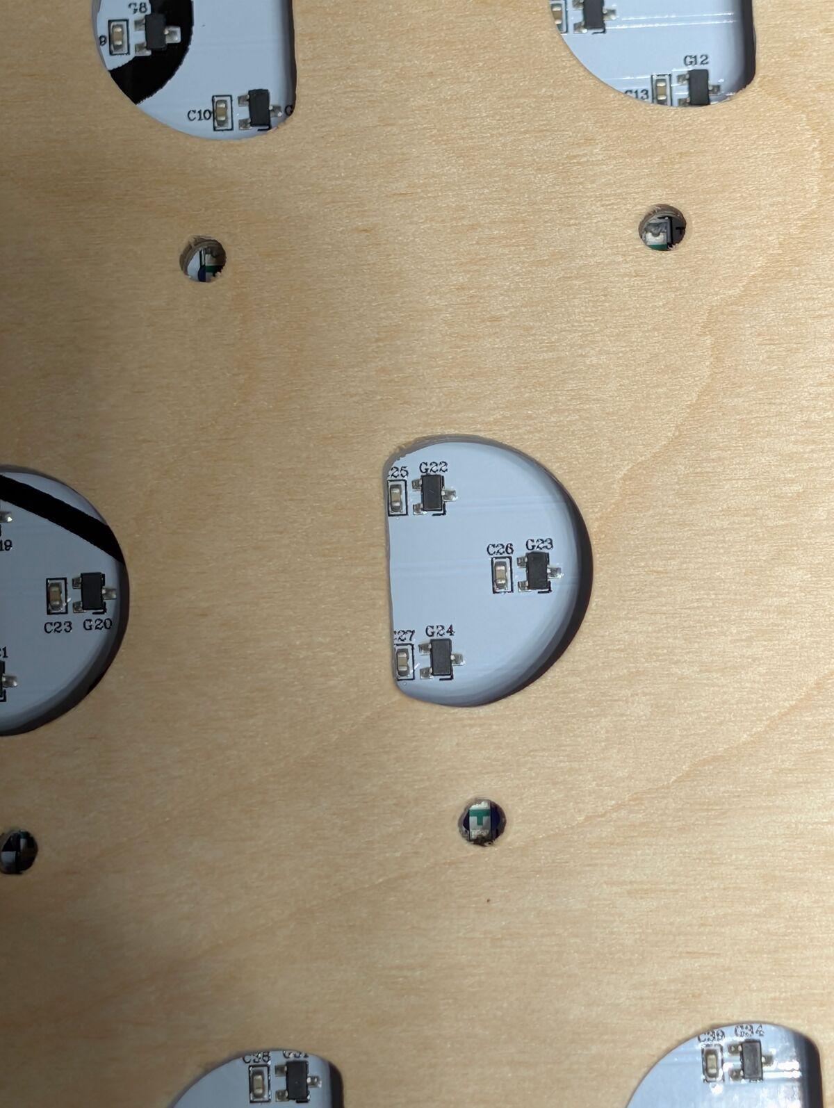 Hall effect sensors visible through the plywood cutouts, three per tile slot in a triangular arrangement.
