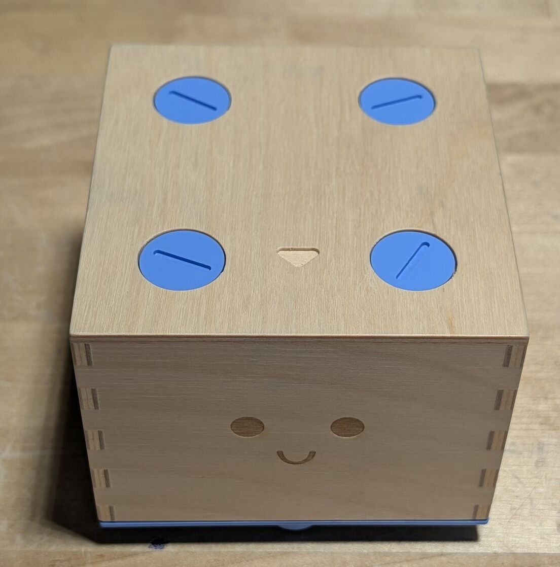 Cubetto. Four blue screws, a coin, and curiosity.