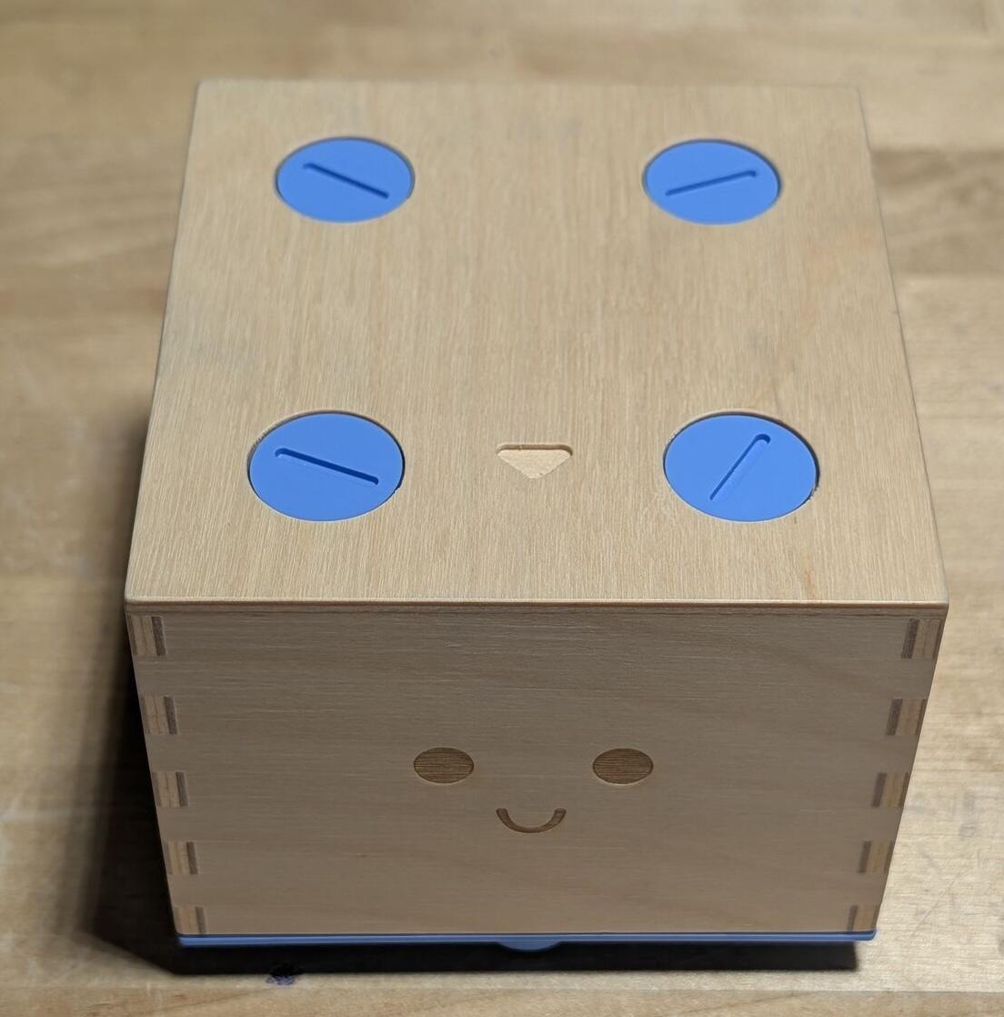 Cubetto. Four blue screws, a coin, and curiosity.
