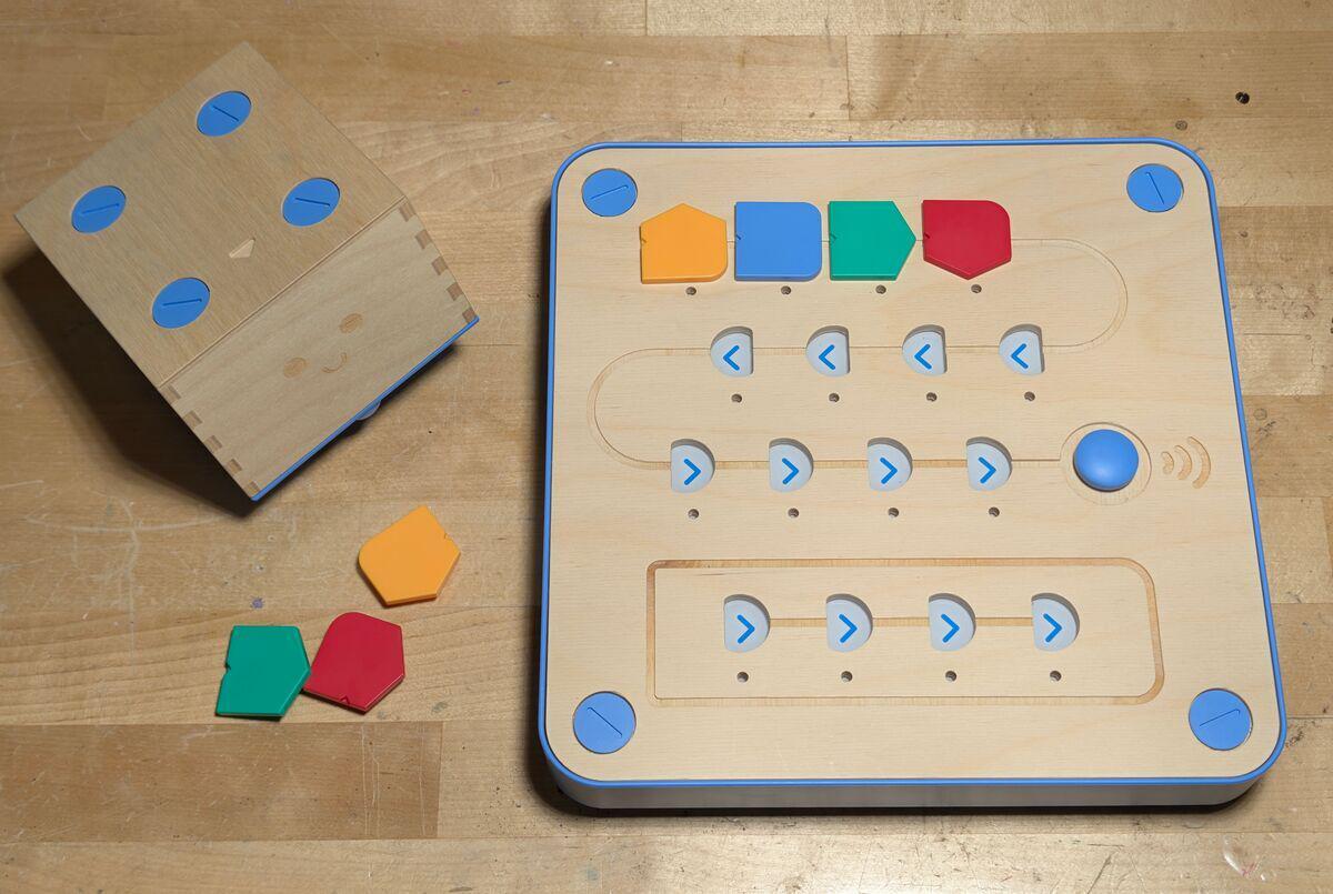 The Cubetto kit: robot, control board with coding tiles, and the colored blocks that make up the instruction set.