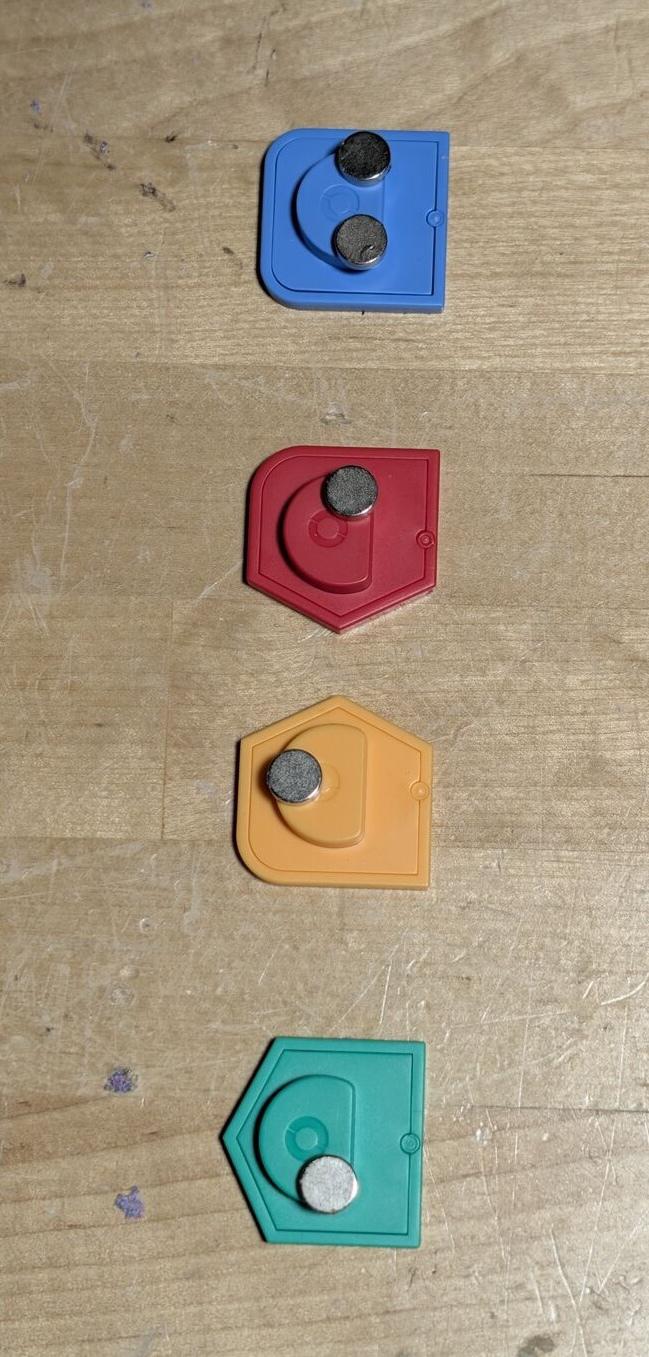 The tiles contain no electronics, just magnets in different positions. Discovered by waving neodymium magnets over the underside and seeing where they grabbed.